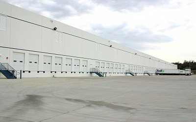 A large warehouse with many doors and stairs.