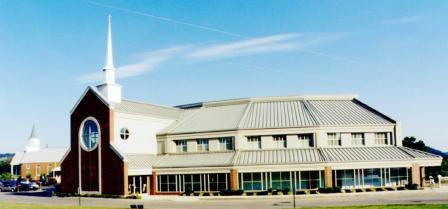 A large building with many windows and a sky background